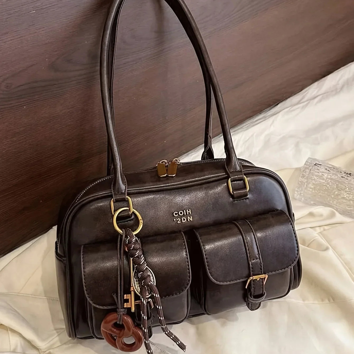 Faux leather bag with vintage design and accessory decoration