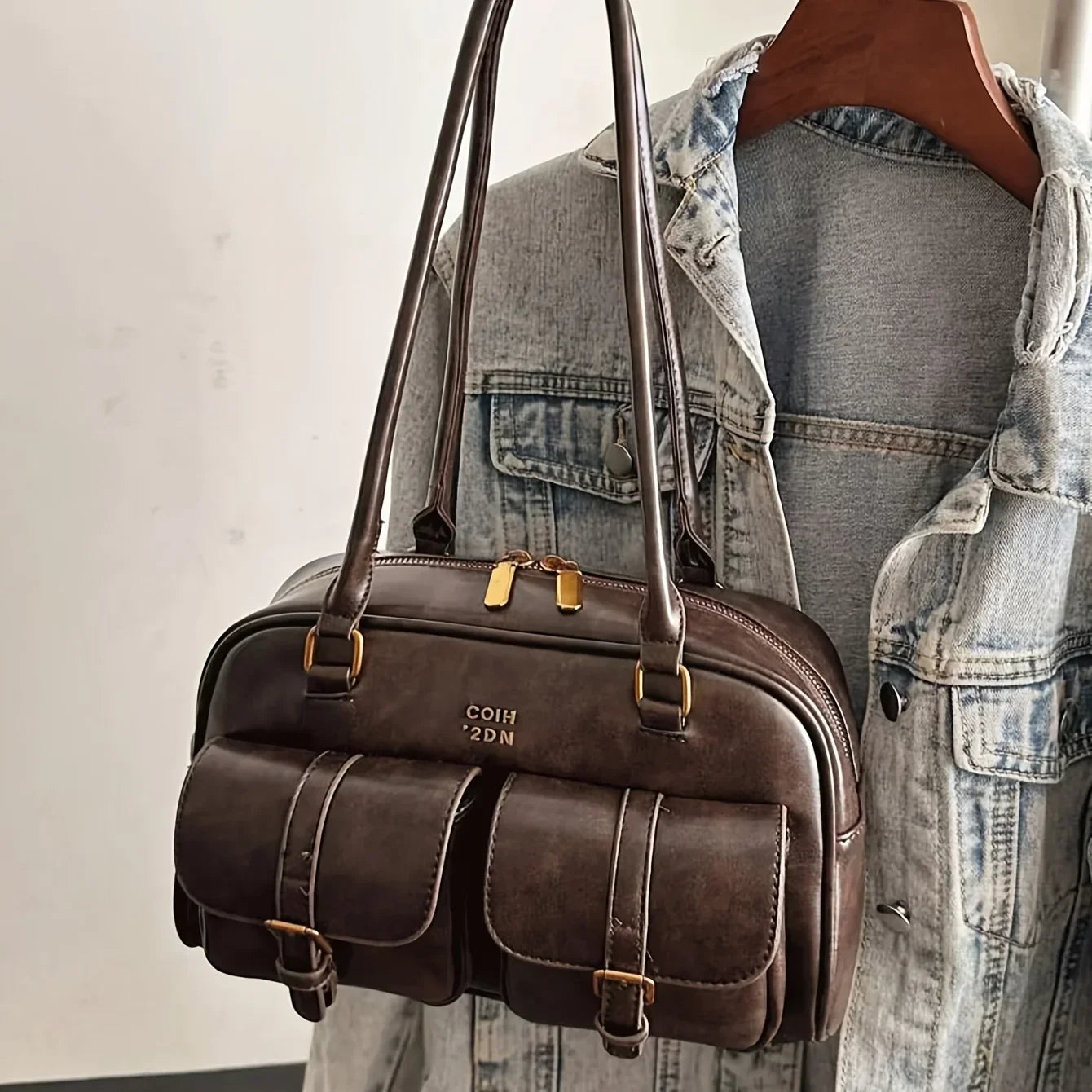 Faux leather bag with vintage design and accessory decoration